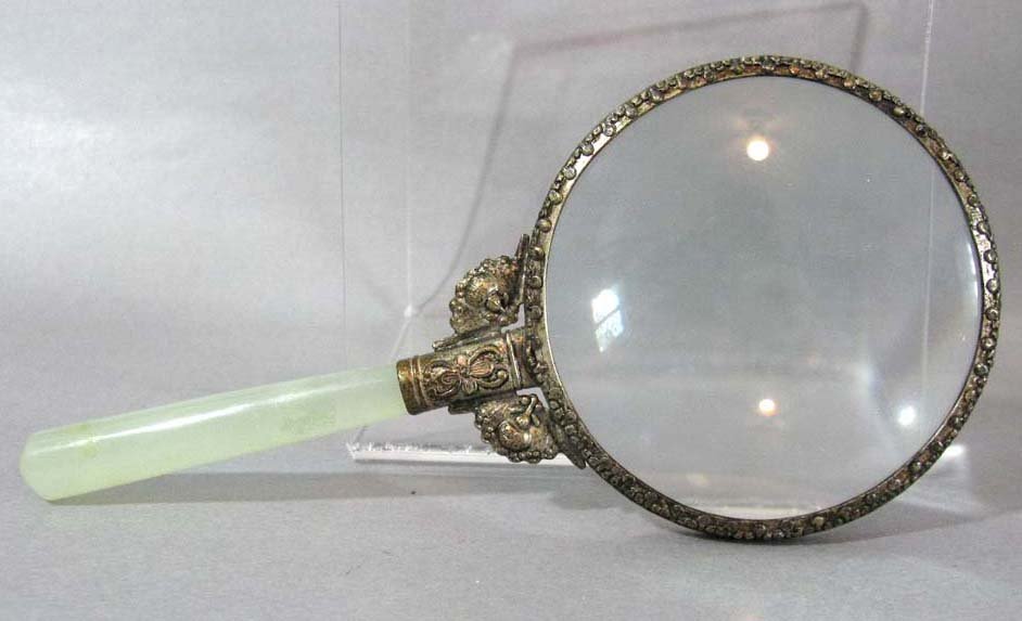 CHINESE JADE HANDLED MAGNIFYING GLASS: Chinese Jade Handled Magnifying Glass; glass is bezel set into a white metal mounting 6.687"l. PROVENANCE: From an established collection created over fifty years ago by a dedicated collector of Asian