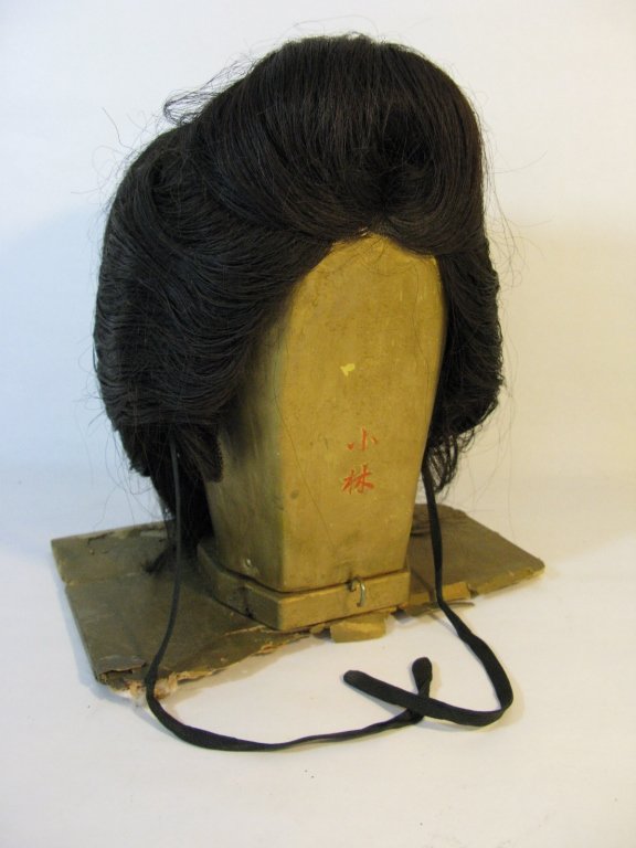 AUTHENTIC GEISHA HEADDRESS WIG IN CASE: An authentic, vintage, Japanese Geisha headdress / wig housed on the original stand with Japanese characters and in case.
