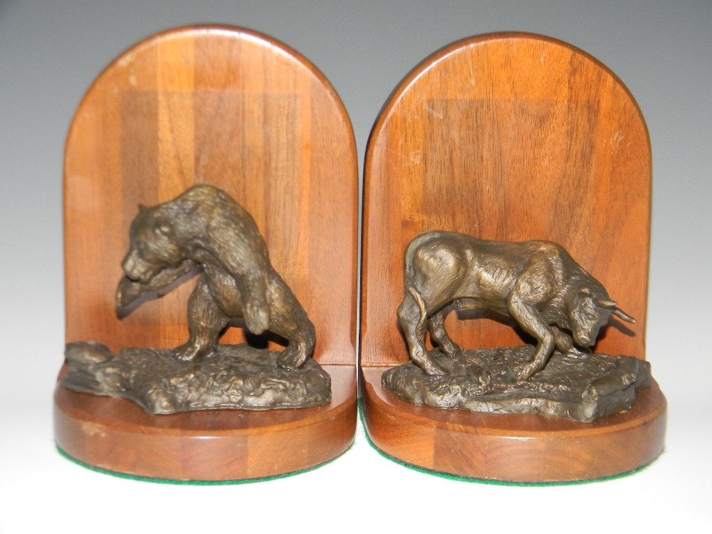S. A. EFRON BULL AND BEAR BRONZE BOOKENDS: A pair of bookends signed in the casting by S.A. Efron (American, 20th century), depicting a bronze sculpture of a charging bull and attacking bear mounted to wood bases, each 6.5"h x 5"w.