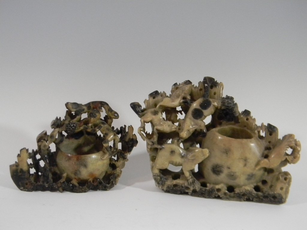 2 CHINESE CARVED SOAPSTONE VASES WITH ANIMALS: Two Chinese figural vases carved in spotted soapstone. 1.) Depicting four legged animals and birds, 6"h x 7.25"w. 2.) Depicting a monkey and animals surrounding a vase with an etched floral pattern, 4