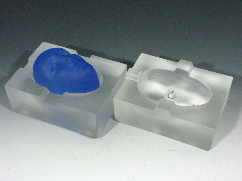 BERTIL VALLIEN GLASS BLUE BRAIN FOR KOSTA BODA: Bertil Vallien (b. 1938, Sweden) for Kosta Boda three piece glass "Brain" with human head and a two piece mold, when assembled measures:3.25"h x 4.25"l x 3.25"w, signed, "KOSTA BODA B. Vallien 20035"