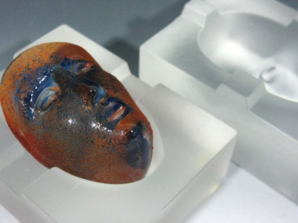 BERTIL VALLIEN GLASS BRAIN FOR KOSTA BODA: Bertil Vallien (b. 1938, Sweden) for Kosta Boda, three piece glass "Brain", head in blue glass with orange overshot and a two piece mold, when assembled measures:3.25"h x 4.25"l x 3.25"w, base signed,