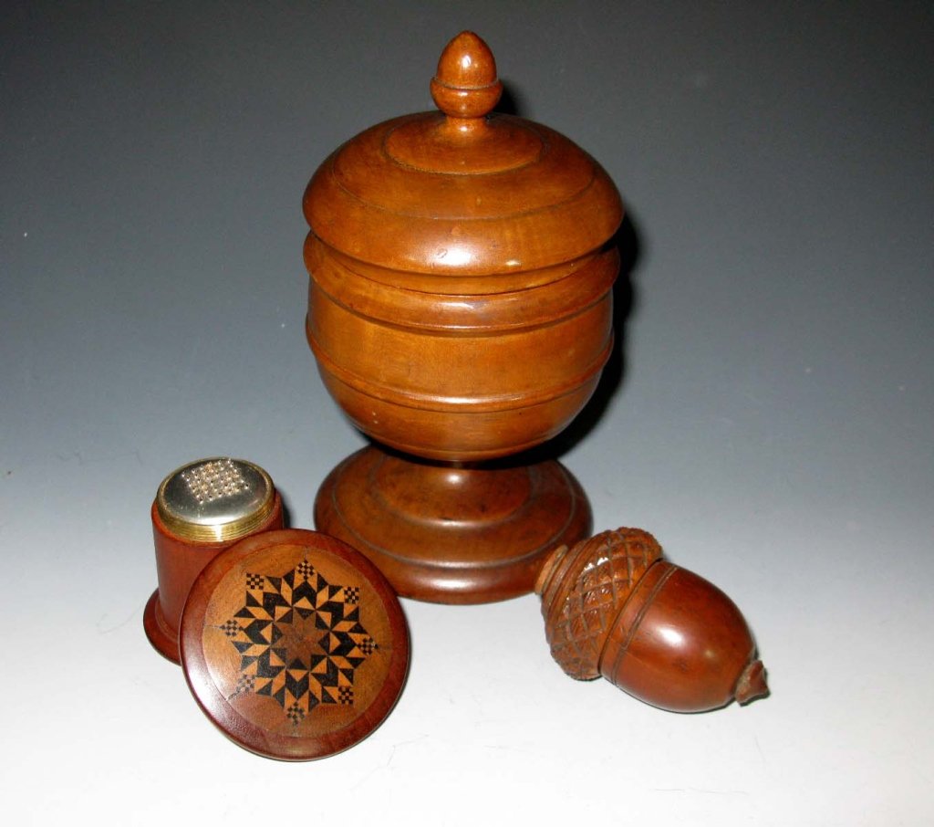 WOOD & COQUILLA NUT NUTMEG GRATER & COVERED CUP: A collection of 19th century, inlaid, carved and turned objects made of coquilla and wood; to include: two nutmeg or spice grinders one of carved coquilla nut in acorn form, 3"l, one treenware of turn