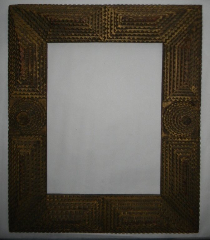 AMERICAN FOLK / TRAMP ART WOOD FRAME 19th C.: American folk art or tramp art picture or mirror frame of carved, applied and gilded wood, exterior dimensions: 18"h x 16"w x 1.75"d, capable of holding 13.25"h x 10"w. PROVENANCE: directly from the l