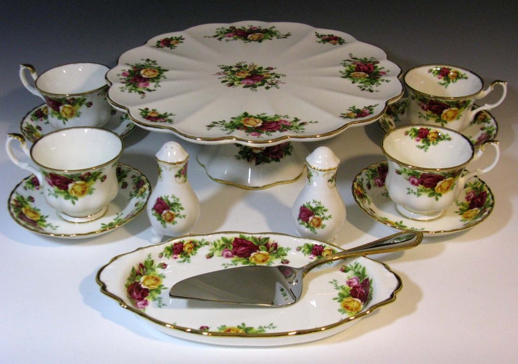 ROYAL ALBERT OLD COUNTRY ROSES DESSERT CHINA: Group of Old Country Roses Bone China Dinnerware and Serving Pieces. The collection includes: 1.) Large Pedestal Serving Plate with Gilded Scalloped Rim, 4.25"h x 12.25"d. 2.) 4 @ Footed Tea Cups, 2.7