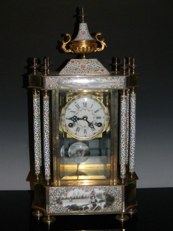 CHINESE ENAMEL PENDULUM MANTEL CLOCK: CHINESE ENAMEL PENDULUM MANTEL CLOCK: The elaborately hand-painted clock with eight feet supporting a brass and painted porcelain base upon which 8 columns surround a thickly beveled case housing a wh