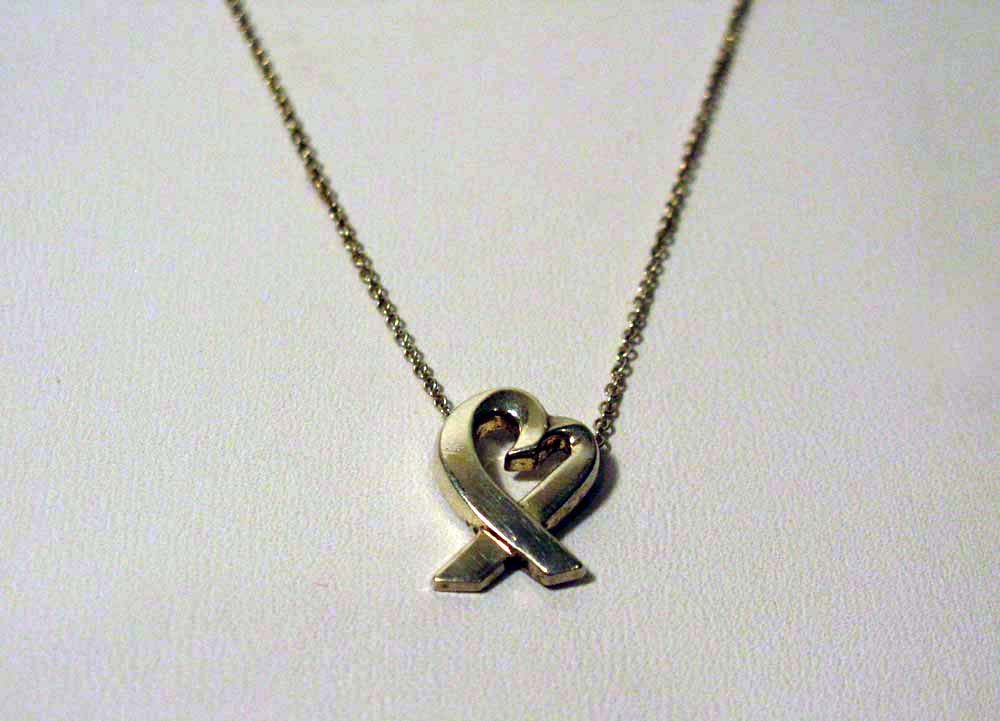 PALOMA PICASSO STERLING HEART PENDANT FOR TIFFANY: Paloma Picasso's, sterling silver, "Loving Heart" pendant and chain designed for Tiffany & Co. The 'Loving Heart' Symbol is Paloma Picasso's unique interpretation of the Iconic symbol for Love. Heart 