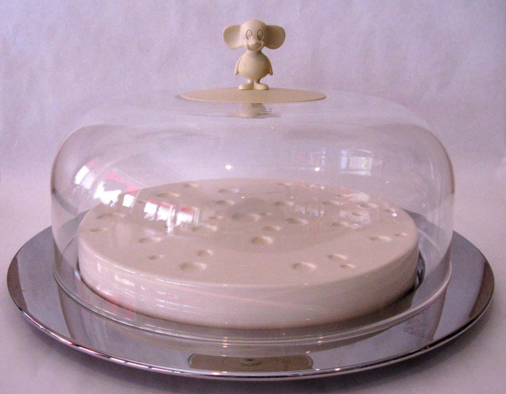 ALESSI ITALY, MICHAEL GRAVES CHEESE BOARD KEEPER: ALESSI ITALY, MICHAEL GRAVES CHEESE BOARD KEEPER: Mirror finished server holds a ceramic wheel of "cheese" used as a tray the whole covered by a dome topped with a mouse finial. Total dimensions: 14.5
