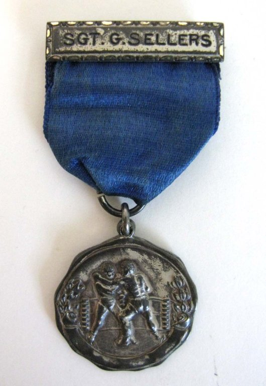 SGT. G. SELLERS 1925 STERLING BOXING MEDAL: 1925 Sterling silver boxing medal with blue satin ribbon presented to Sergeant G. Sellers, engraved on back : FEATHERWEIGHT MED. DET. 106-CAV. 1925." Medal and riband both stamped STERLING. Total dime