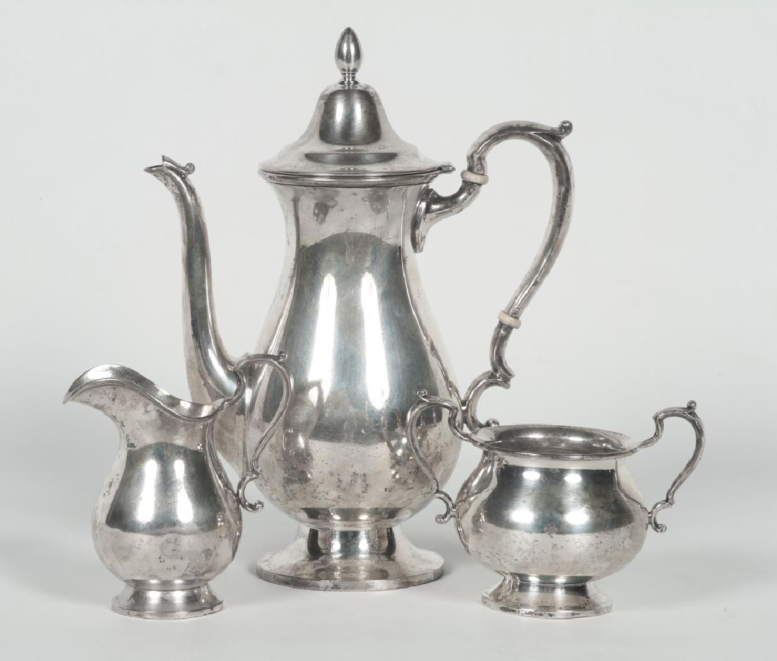 Fisher Silversmiths Sterling Silver Coffee Service: Early 20th century, New York or New Jersey. Queen Anne style service consisting of a teapot, cream and sugar. 23.0 oz standard Good condition overall. Small bend to the foot of the creamer. H9 ½" H4 