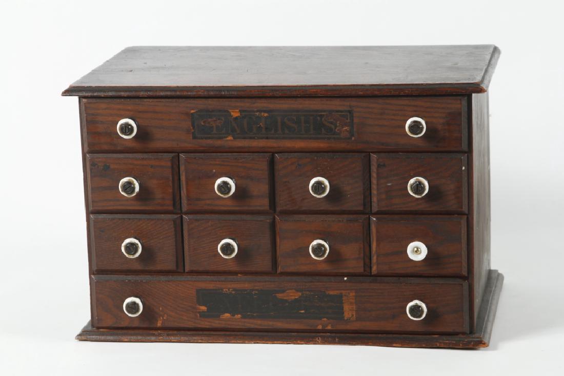 Antique Oak Country Store Cabinets: likely America, late 19th century. Having original store label reading, “English’s” at both top and bottom drawer. Consisting of six drawers with porcelain pulls. Secondary wood looks to be popl