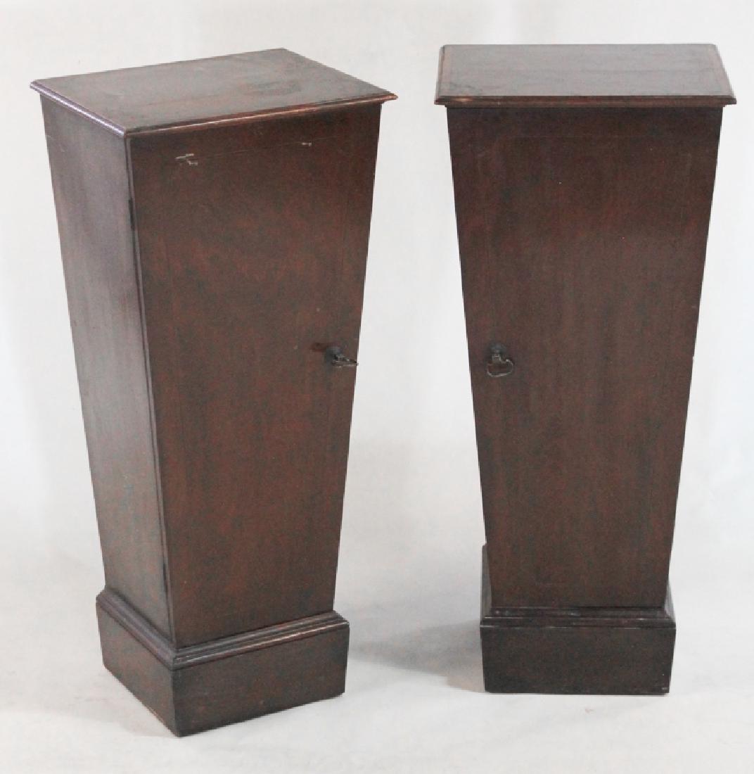 Edwardian Mahogany Serving Pedestals: Britain, late 19th/early 20th century. Inlaid trapezoidal shaped pedestals with two shelves behind hinged doors. H36" W15 3/4" D13" Collection of Dr. Jack Dillard Ashley, Columbia, SC.