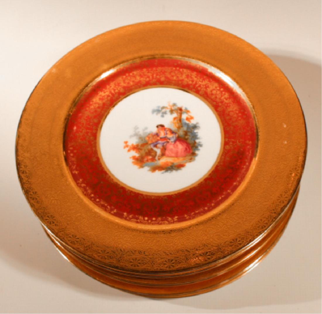 Nine Royal Crown Transfer Decorated Dinner Plates: Early to mid 20th century, England. Having 22kt gold gilt border with transfer decoration of renaissance period man and woman at center surrounded by rich red border. Good condition throughout with so