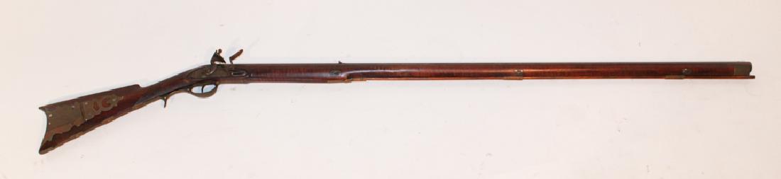 American Flintlock Maple Long Rifle: Early 19th century. Marked at the lock "Green & Wetmore Warranted". The stocking having a handsomely inset brass patch box which leads into the butt plate and continues up the the trigger guard. The u