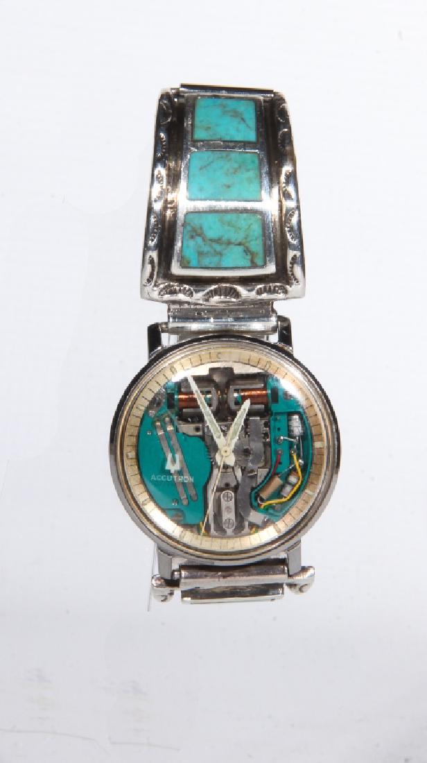 Vintage Bulova Accutron Space Watch: Circa 1964. Having very interesting design and accompanied by a vintage turquoise and silver band which is likely custom made. Good working condition here in the gallery.