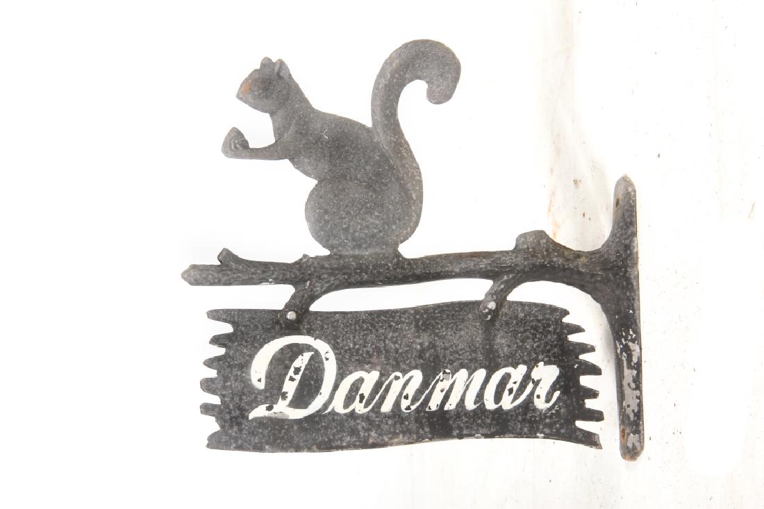 Antique or Vintage Metal Sign or Wall Shingle: Circa 1900. Figural piece in the form of a tree branch with handsome squirrel at top and sign below which is painted with the name â€œDanmarâ€. Some loss to the surface consistent with age. H10
