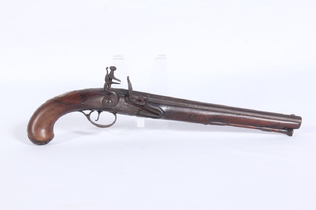 Early Antique British Flintlock Pistol: 18th or early 19th century. Having a strong form with handsomely carved stock inset with barrel which has stars chased into the topside and is marked twice at the top of the barrel. One left facing li