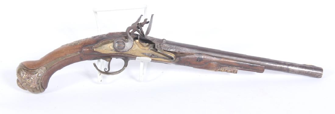 Early Antique Continental Flintlock Pistol: 18th century, likely Dutch or German. The pistol having an elaborately decorated stock with two marks on the barrel one mark is â€œDPâ€ below a crown and the other mark is very difficult to dec