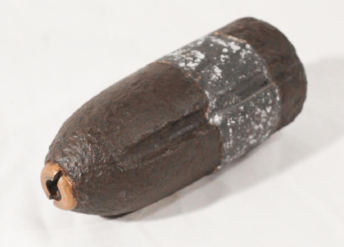 Unarmed Civil War Projectile: Mid 19th century. Of the period, comprised of two types of metal along with a brass head. L 7" W 3 1/8" Sold from a private Charlotte, North Carolina collection.
