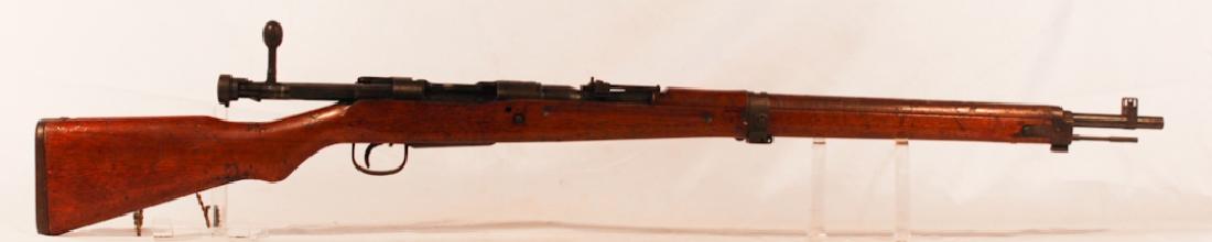 Japanese World War Two Arisaka Type 99 Rifle: Having makers mark at the top of the barrel in Japanese characters. Good overall condition with no restoration to stock. Bluing appears to be original. Sold from the collection of a private Aiken, Sou