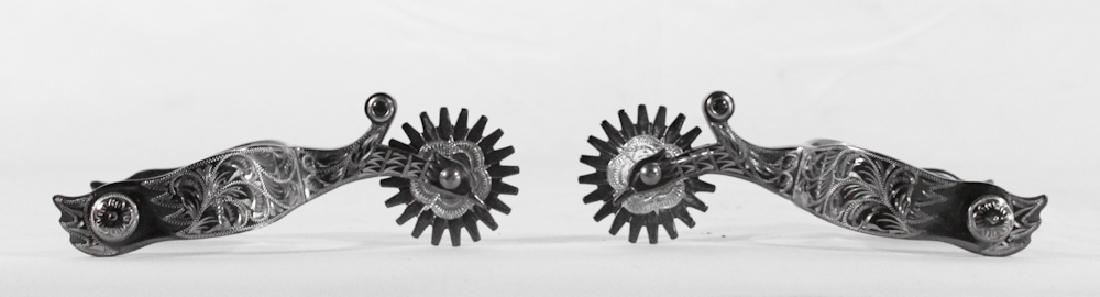 Colorado Saddlery Company Custom Spurs: Handsomely chased and well-detailed. Marked at the interior with makers mark. Good condition. L7 1/2"