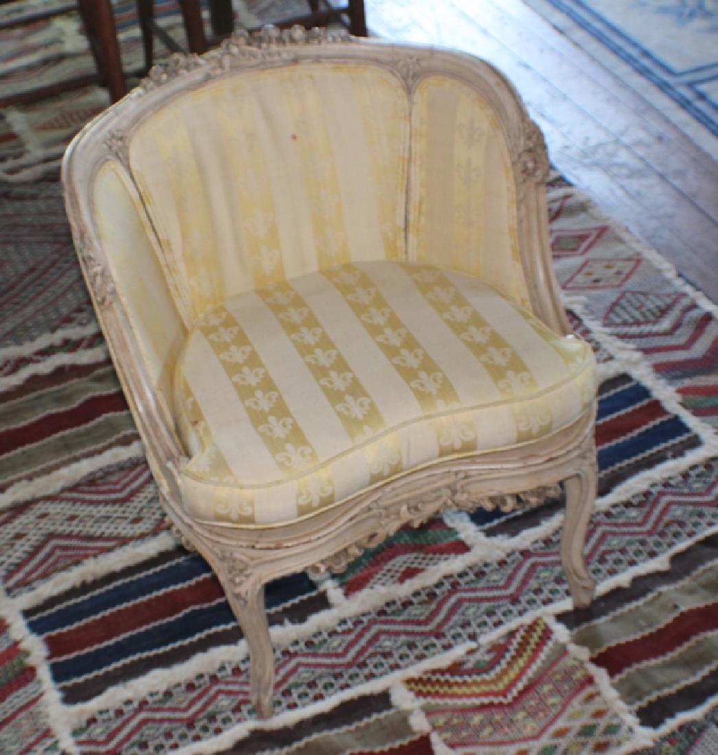 French Century Carved & Polychrome Slipper Chair: 18th or early 19th century. Having a very nicely carved frame with acanthus and floral detail and a nice yellow silk and cloth fabric with fleur de lis. H25" W22 1/2" D21" Sold from the collection of 