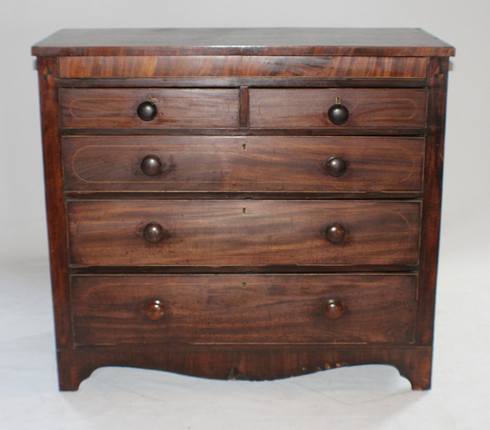 George III Inlaid Mahogany Chest of Drawers: Circa 1810, Britain. Having a rectangular top above a hidden top drawer with banding continuing down to two over three drawer configuration all resting on a bracket foot. H41 7/8" W46 1/8" D20 1/2" So