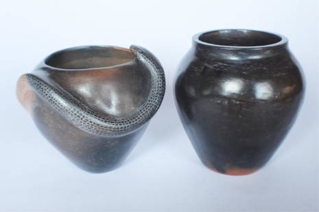 Two Southern Native American Pottery Vessels: Catawba Indian, 21st century by Eric Canty. One handsomely potted snake bowl together with an ovoid traditional vessel. Each signed at the base. Good condition throughout. H6 1/2" Sold from the collec