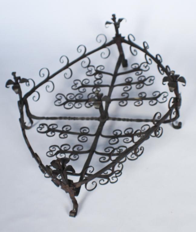 Antique Mexican Wrought Iron Centerpiece: 19th century. Having a diamond form with intricate scroll work and floral detail at corners all atop four scrolling feet. H6" W23" Sold from the collection of a Cheraw, South Carolina couple.