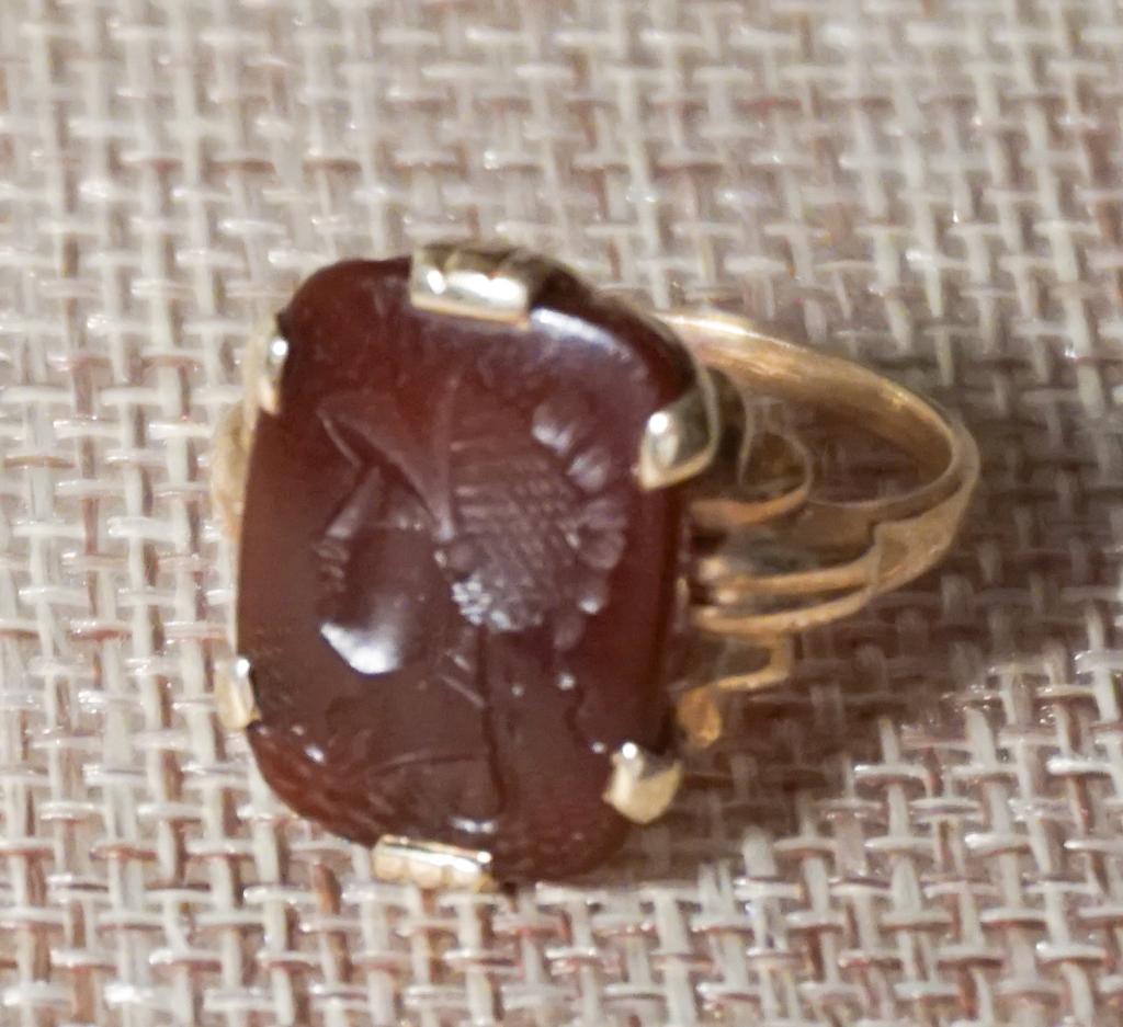 Antique 10k Gold & Carved Carnelian Intaglio Ring: Square intaglio with roman head carved at center inset into gold band. 3.6 grams. Size 7. All jewelry lots in this sale have been professionally examined by a jeweler and authenticated.
