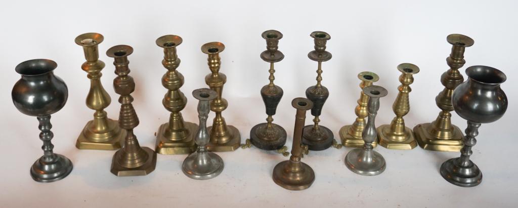 Collection Antique Brass & Pewter Candlesticks: 18th and 19th century. The group includes a variety of sizes and ranges from Queen Anne period into the Victorian Era. Sold from the collection of Mrs. Joanne Pirkle of Buckhead, Atlanta Georgia.
