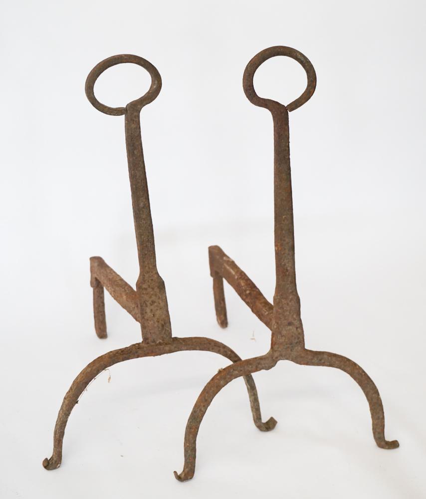 Pair Country Federal Wrought Iron Andirons: Early 19th century, likely Backcountry, South Carolina or Georgia. The pair having a nicely formed shaft with handle at top and all resting atop scrolling tip legs. H17 3/4" W10" D11 3/4" Discovered i