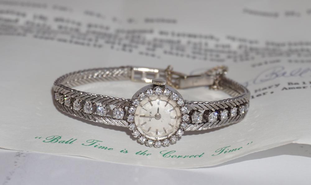 18k White Gold & Diamond Ladies Wrist Watch: by Armin Kurz . Mid 20th century, Zurich. The piece having 20 round full cut diamond bezel set around the dial with seven full cut diamonds set at each side inside of split design 18k white gold setti