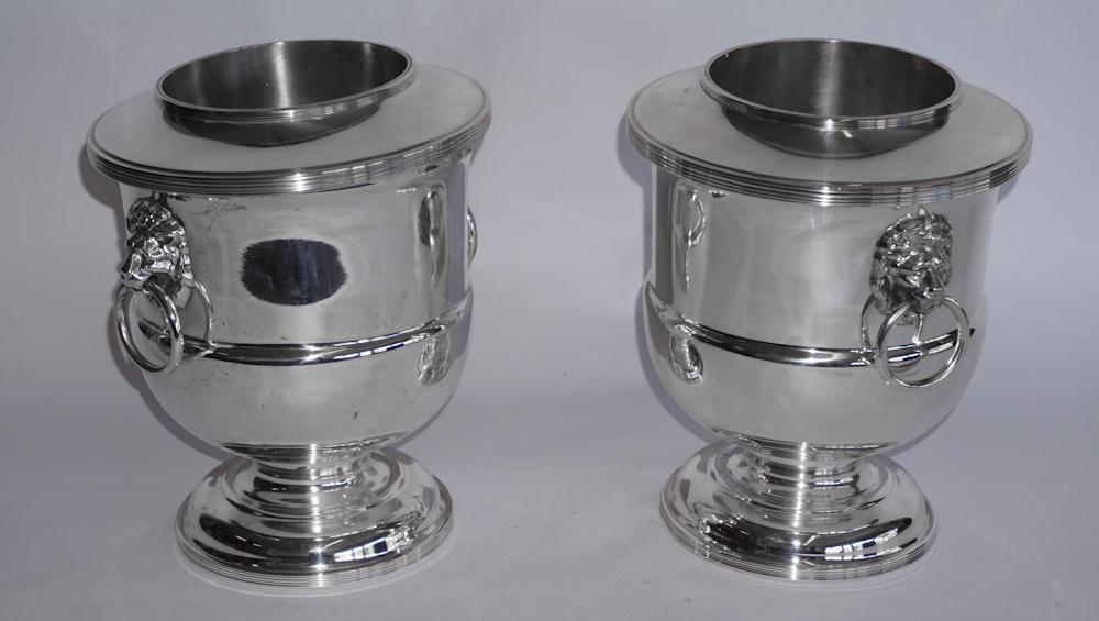 Pair Regency Style Silver Plate Wine Coolers: Likely early 20th century, Sheffield. The pair have a nicely formed body with lionshead bale handles at each side. The top is removable to house ice inside. H9 1/8" W9" Sold from a Kiawah Island, Sout