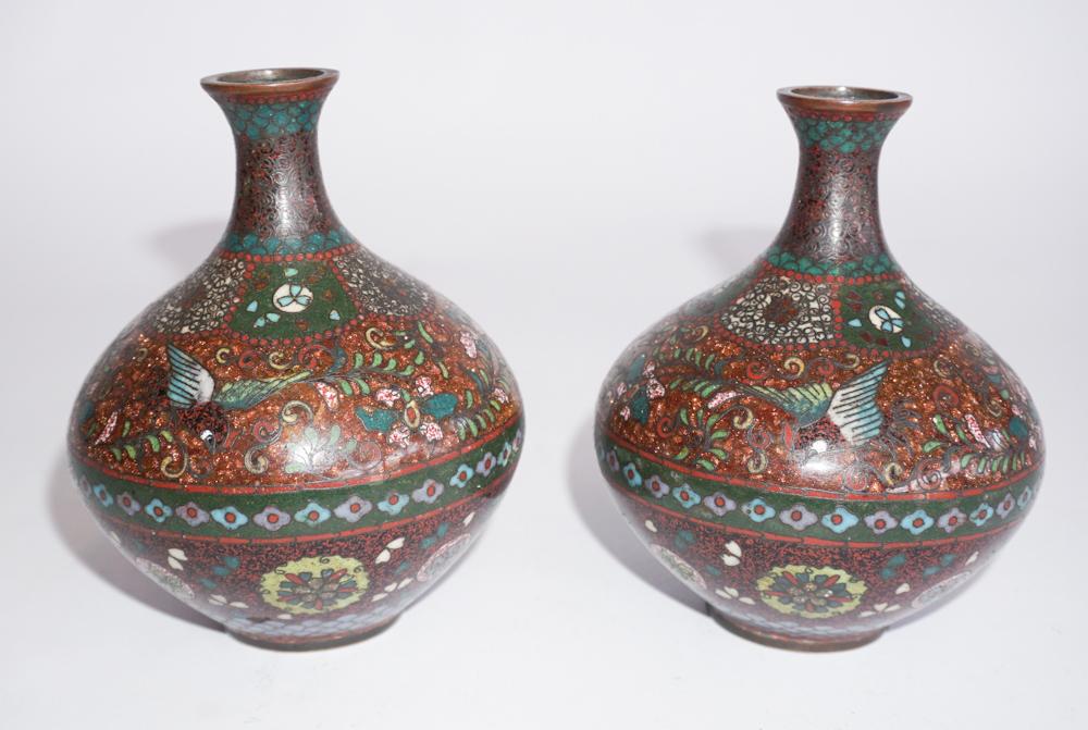Two Antique Japanese Meiji Period Bud Vases: 19th century. Each conforming with excellent cloisonne detailed body and nice colors throughout. Good overall condition with no strikes or cracks detected. H4 1/2" Sold from the collection of a Southe