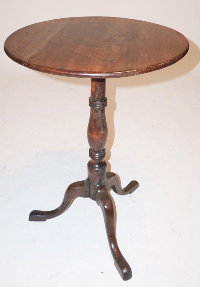 George III Mahogany Tilt Top Candle Stand: Circa 1800. Having a circular top with hinge attached to turned wood base emitting three scrolling legs ending in pad feet. H27 1/2" W19 1/2" Sold from the collection of a Southern lady.