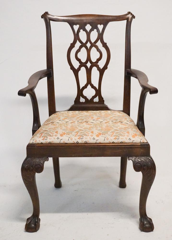 English Chippendale Carved Mahogany Armchair: Late 18th century. Having a very nicely carved and pierced back emitting scrolling arms above acanthus and feather carved legs ending in well executed ball and claw foot. Excellent oriental silk fabri
