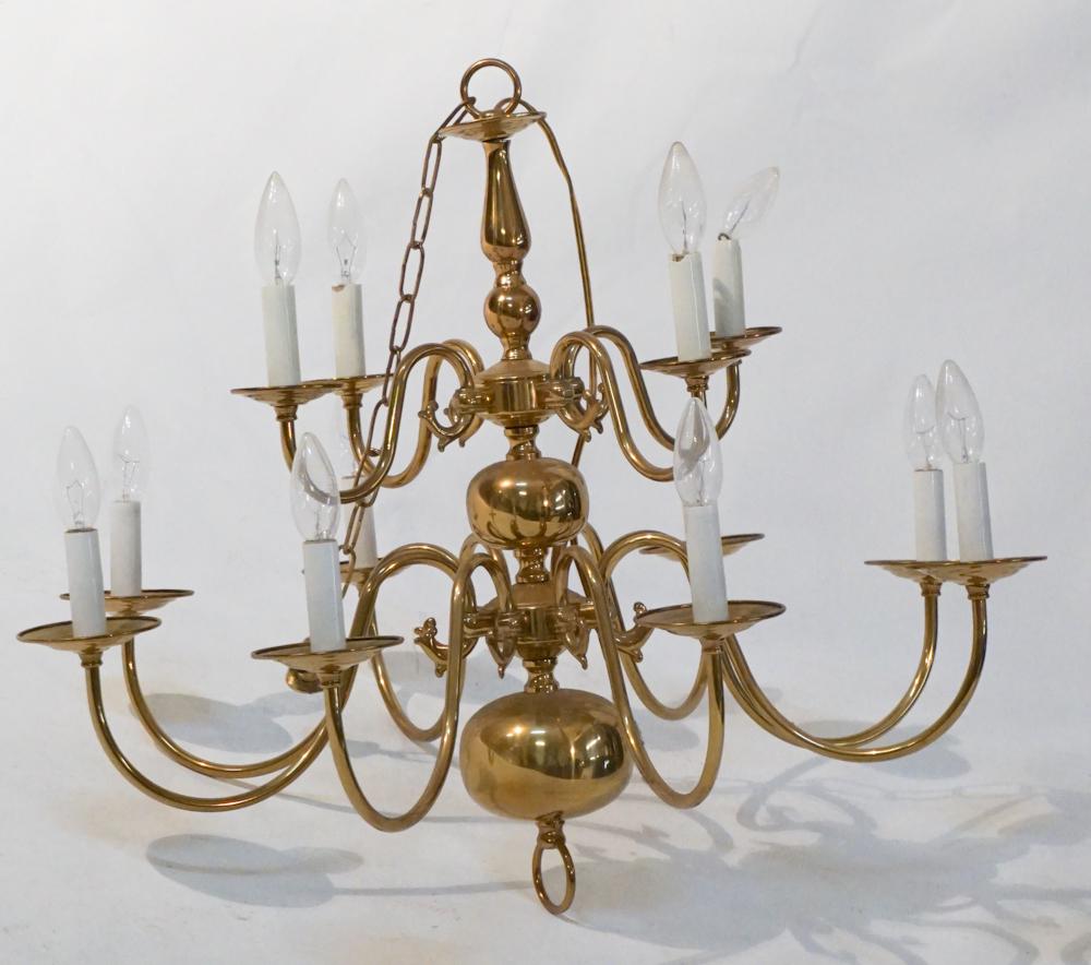 Georgian Style Brass Chandelier: 20th century. Having a nice form with twelve lights. Spun brass body emitting twelve scrolling arms. H21" W28"