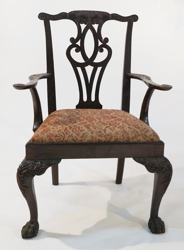 British or American Carved Chippendale Arm Chair: Circa 1770. Having a handsomely carved back and arms atop an upholstered seat leading down to boldly carved legs terminating in a very handsome hairy paw foot. H40" W29 1/2" D21" Sold from the collect