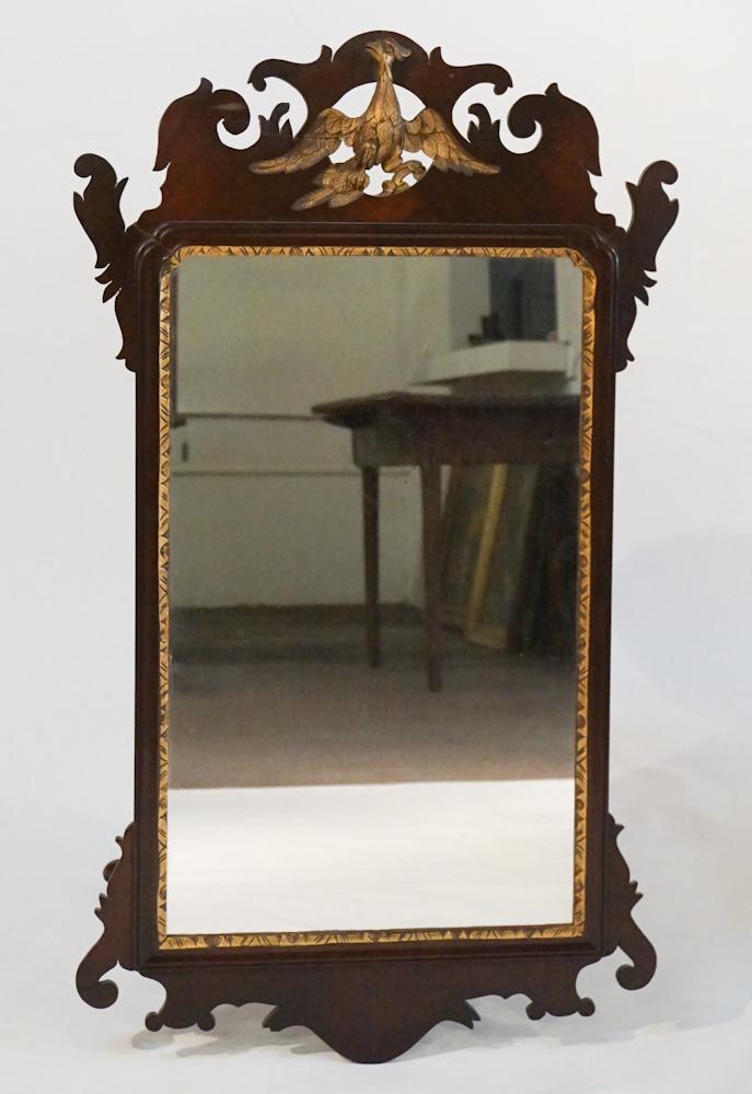 George III Carved & Gilt Mahogany Looking Glass: Circa 1800. Having a nicely carved frame centered by gilt eagle and with scrolling borders around the frame. Good overall condition, some scattered restoration to upper scroll work consistent with age