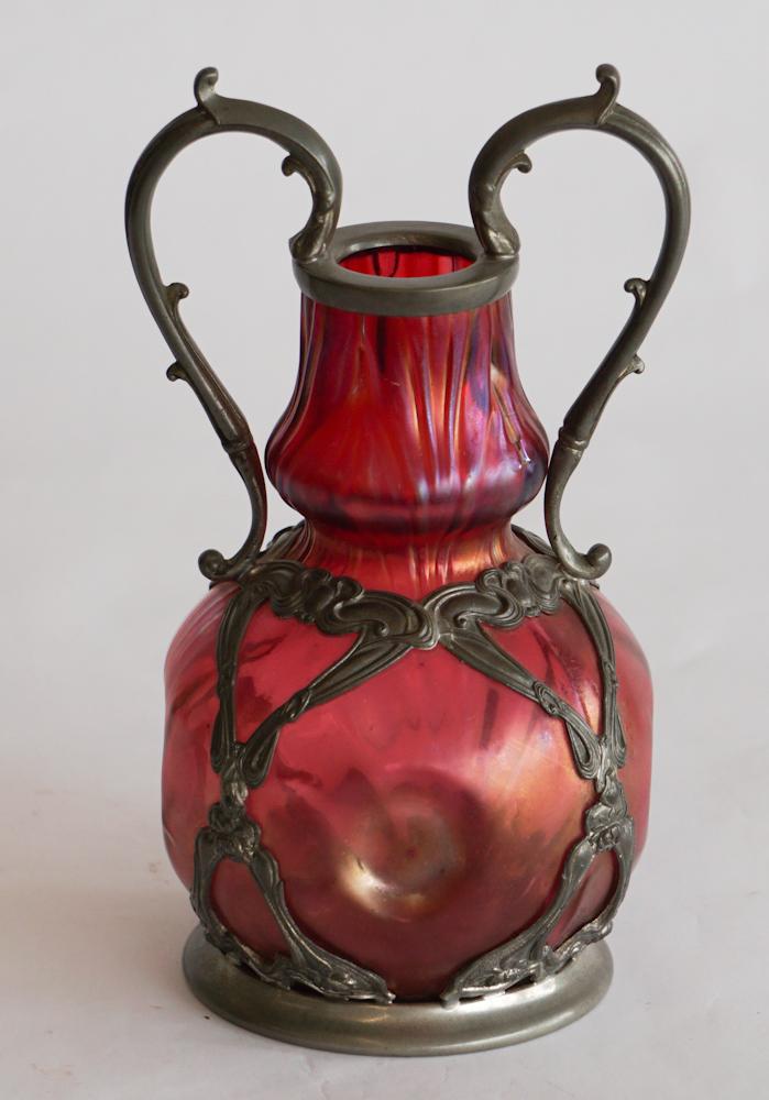 Antique Art Nouveau Period Magenta Glass Vase: Circa 1900, Austria, likely Loetz. The piece having nice colors and well detailed body housed in metal art nouveau mout marked at the base Rieszinn. Good overall condition. H8 3/4" Sold from the colle