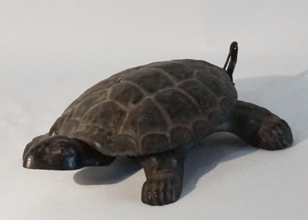 Antique Pressed Metal Lifesize Turtle Spittoon: Early 20th century. Pressed metal turtle with hinged shell to lift open for spitting chewing tobacco inside the shell. Very original surface and in overall good condition. The hinge having a repair. L
