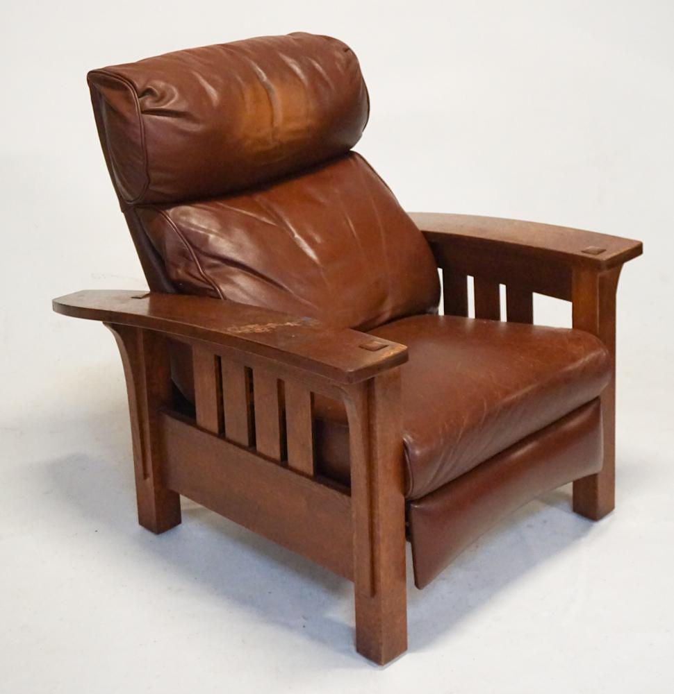 Arts & Crafts Style Stickley Reclining Easy Chair: Late 20th century. Having a handsome leather upholstery on a handsomely formed oak frame. Marked at underside with maker's mark. H38 1/2" W35 1/2" D41" Sold from the collection of a Columbia, SC coupl