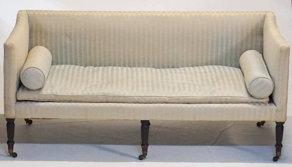 Federal Mahogany Sofa: Circa 1820. Having a handsome frame atop six turned and reeded legs with a single tapered leg at backside. Upholstery is in overall good condition. H34" W73" D29" Sold from the collection of an Edgefi