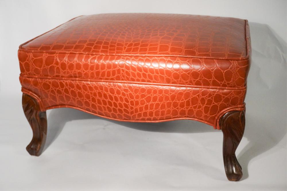 Club Style Faux Alligator Footstool: 20th century. Having nicely embossed upholstery atop carved frame. Good condition throughout. H13" D18" W25" Sold from the collection of a late South Carolina scholar.