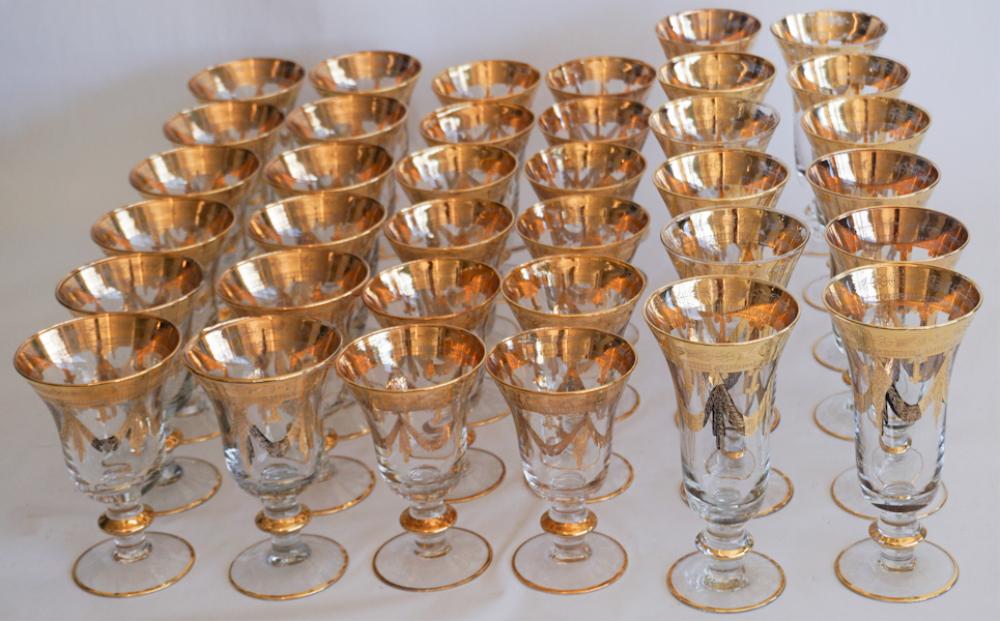Fine Set of 24k Gold on Glass Art Deco Stemware: Mid 20th century. Set having excellent and brilliant gold adorned rim and trim. The set includes 12 large water stems, 10 red wine stems and 10 white wine stems. Good condition throughout. Sold from t