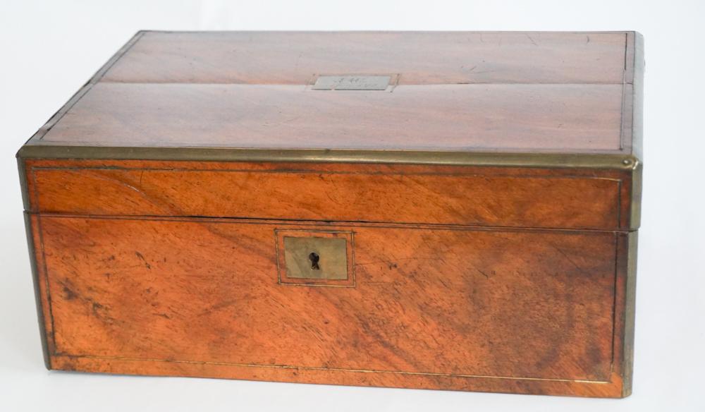 Antique Regency Brass Inlaid Mahogany WritingSlope: Mid 19th century, Britain. Having brass inlaid case with plaque at center chased with date of 1872 and initials EAC. The piece opens to the interior which is nicely appointed with compartments and wri