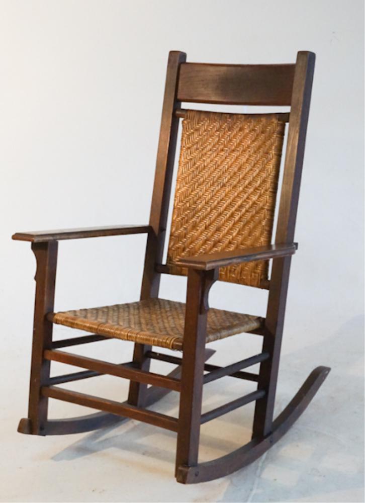 Charming Arts & Crafts Period Oak Rocking Chair: Circa 1900. Having a very fine early surface with excellent woven seat in good sturdy condition. H43" W28" D32"