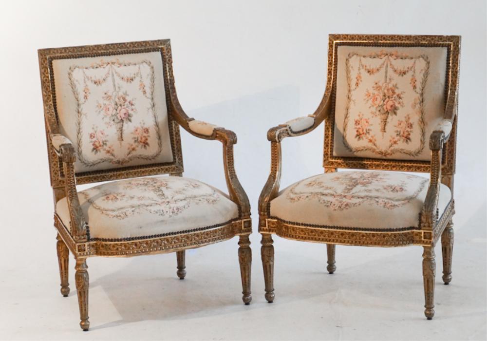 Pair French Carved Giltwood Open Arm Easy Chairs: Likely late 18th century. The handsome pair having a very nicely carved frame with acanthus and vine details, atop four charmingly acanthus carved tapered legs. The back and seat are well upholstered.