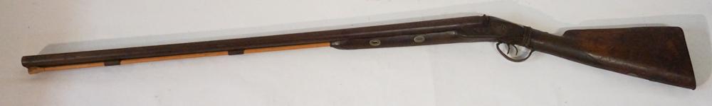10 Gauge Lewis & Tomes Double Barrel Shotgun: Circa 1860. The gun has a 38" barrel and marked at the plate with maker's mark and chases pheasant decoration. The top of the barrel is chased at center reading London Fine Twist. The stock is wire wr